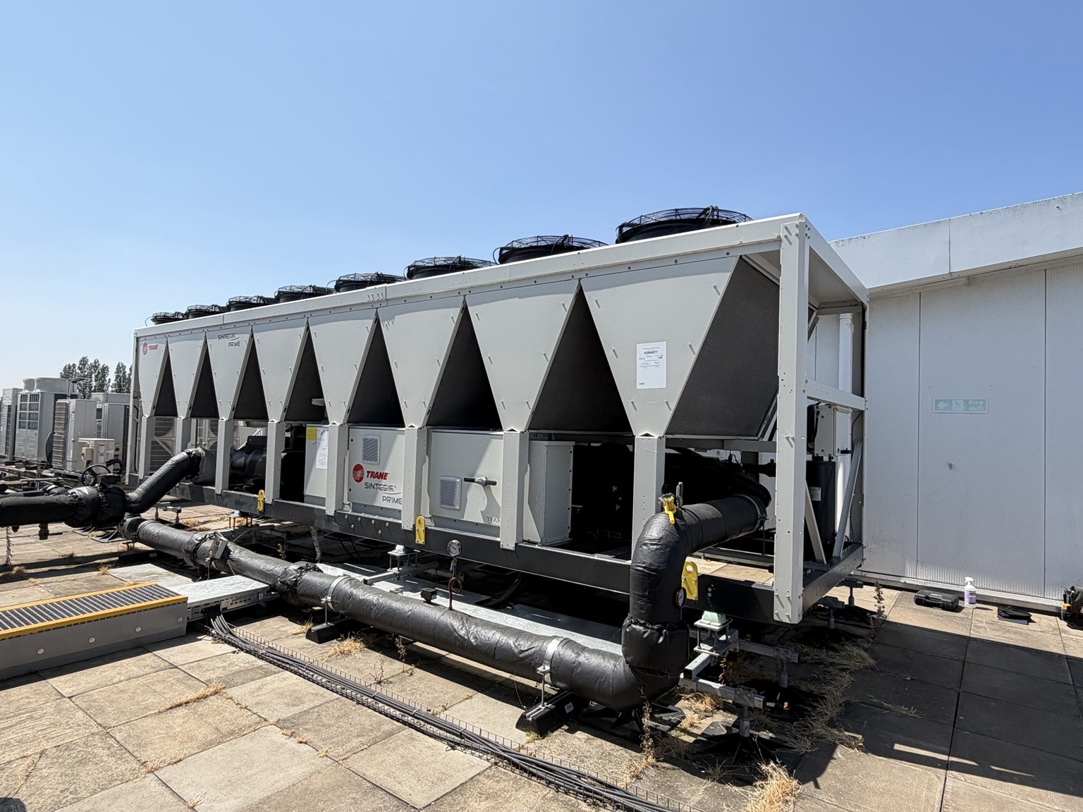 Large Trane rooftop chiller installed on a commercial building